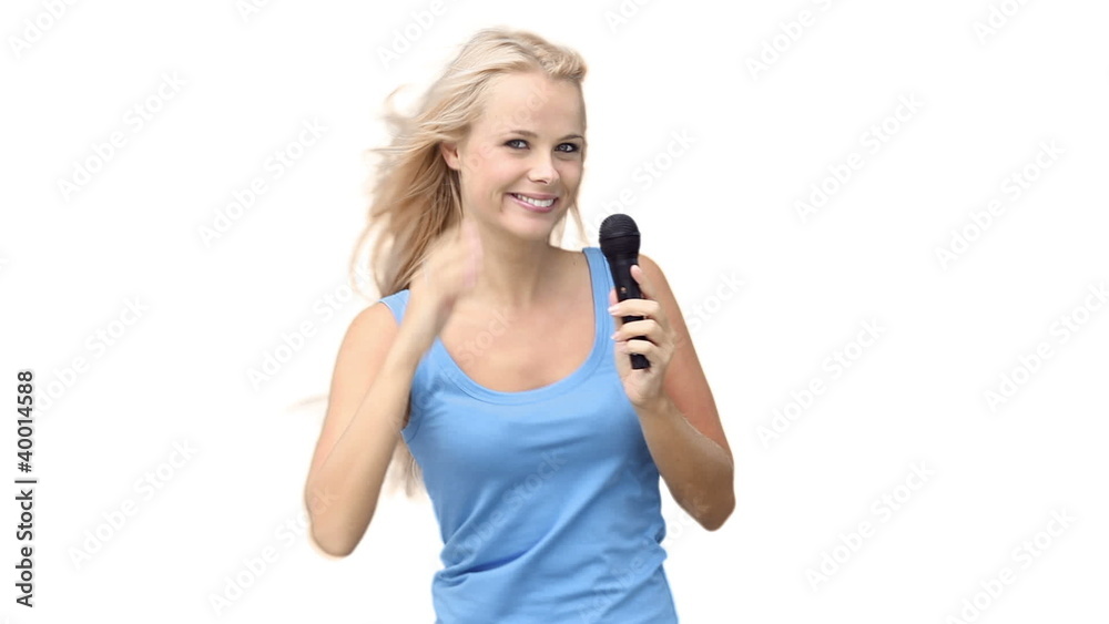 Woman pointing while singing with a microphone Woman pointing while singing with a microphone