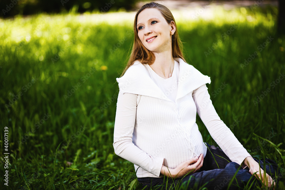Beautiful pregnant woman relaxing in the park Beautiful pregnant woman relaxing in the park