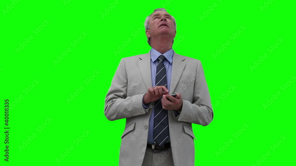 Businessman looking upwards while typing on a laptop Businessman looking upwards while typing on a laptop