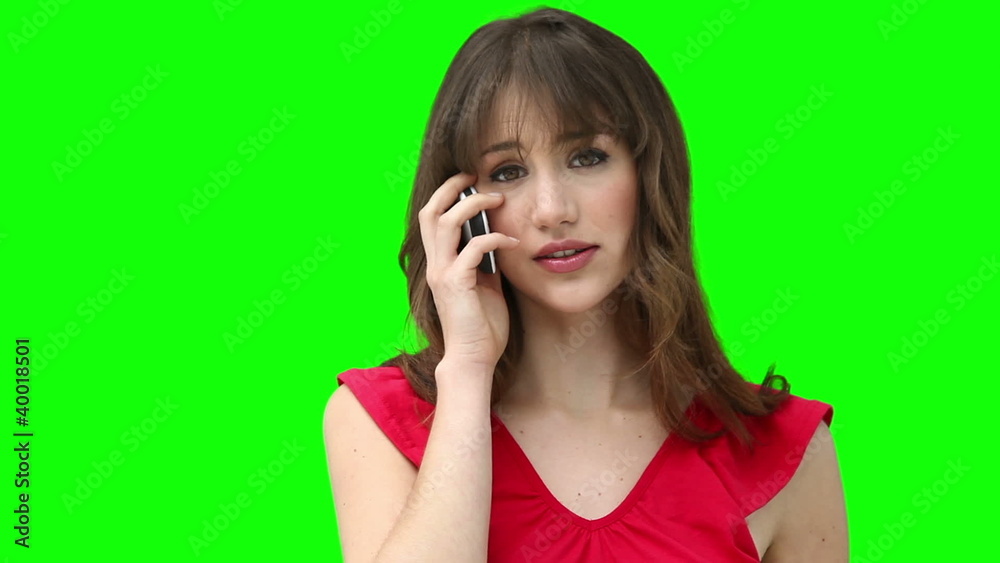 Woman smiling while talking on a cellphone Woman smiling while talking on a cellphone