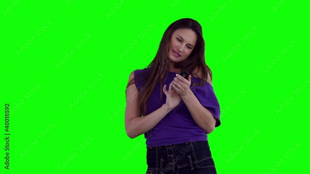Woman smiling while typing on her phone Woman smiling while typing on her phone