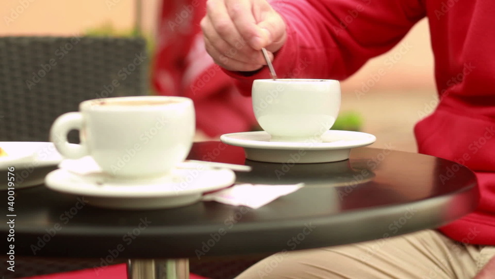 Man drinking coffee in cafe, outdoors, steadicam shot Man drinking coffee in cafe, outdoors, steadicam shot
