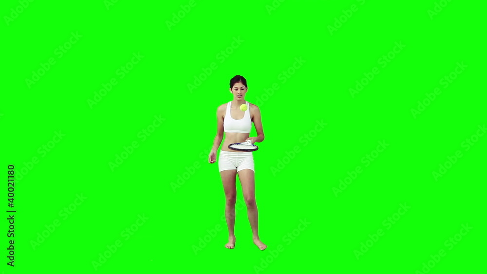 A woman is playing with a tennis racket and ball A woman is playing with a tennis racket and ball