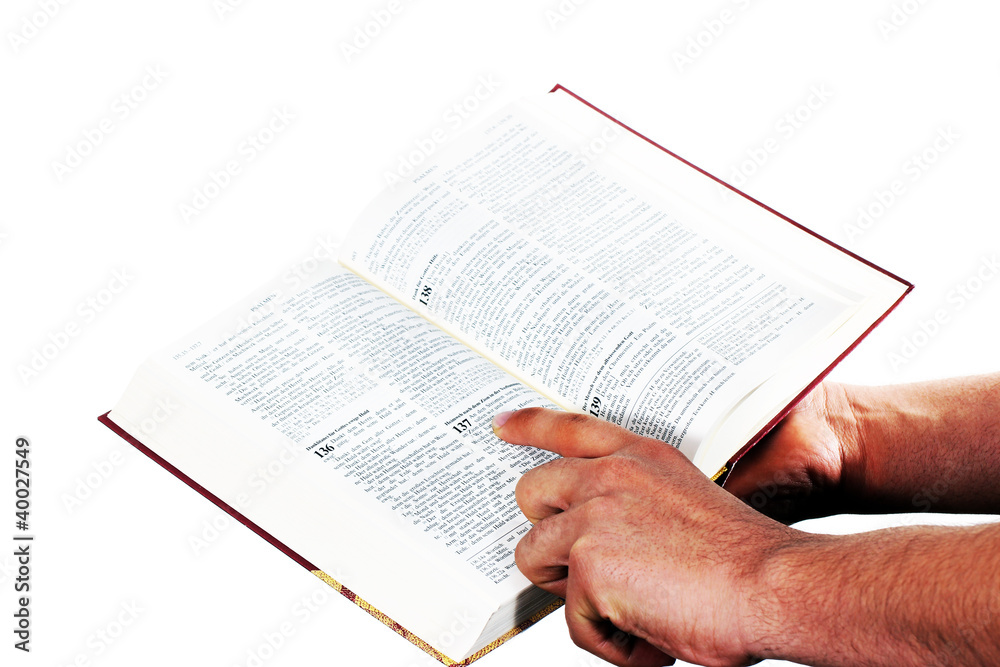Fototapeta premium Praying hand hold an open bible