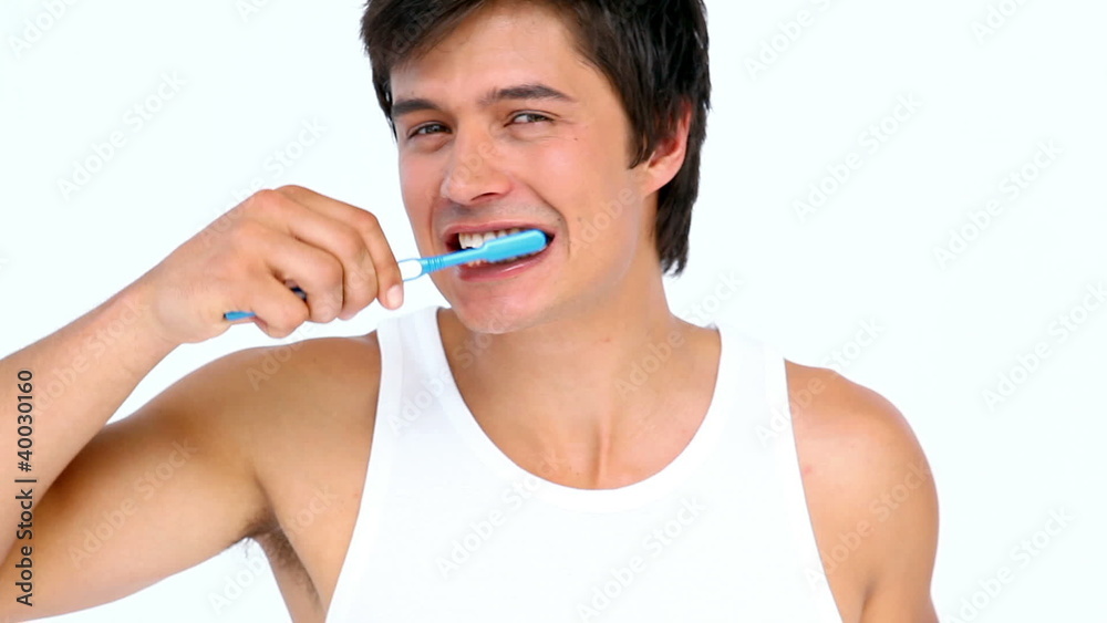 Man brushing and looking his teeth Man brushing and looking his teeth