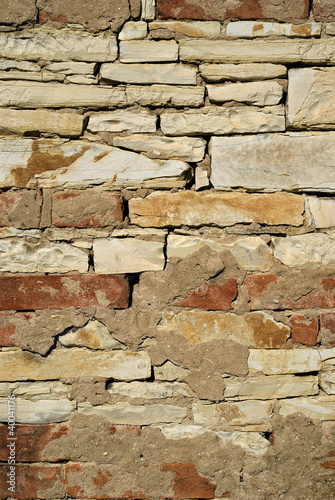 Close up of a brick and limestone stone wall.