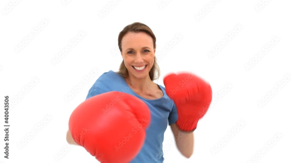 Smiling woman playing with boxing gloves Smiling woman playing with boxing gloves