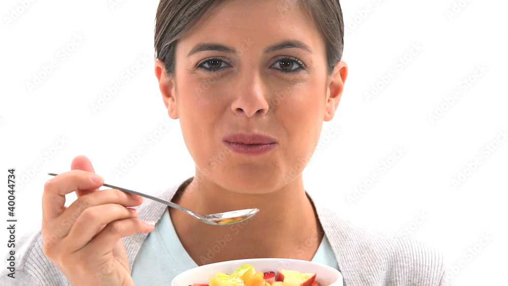 Woman eating fruit salad Woman eating fruit salad