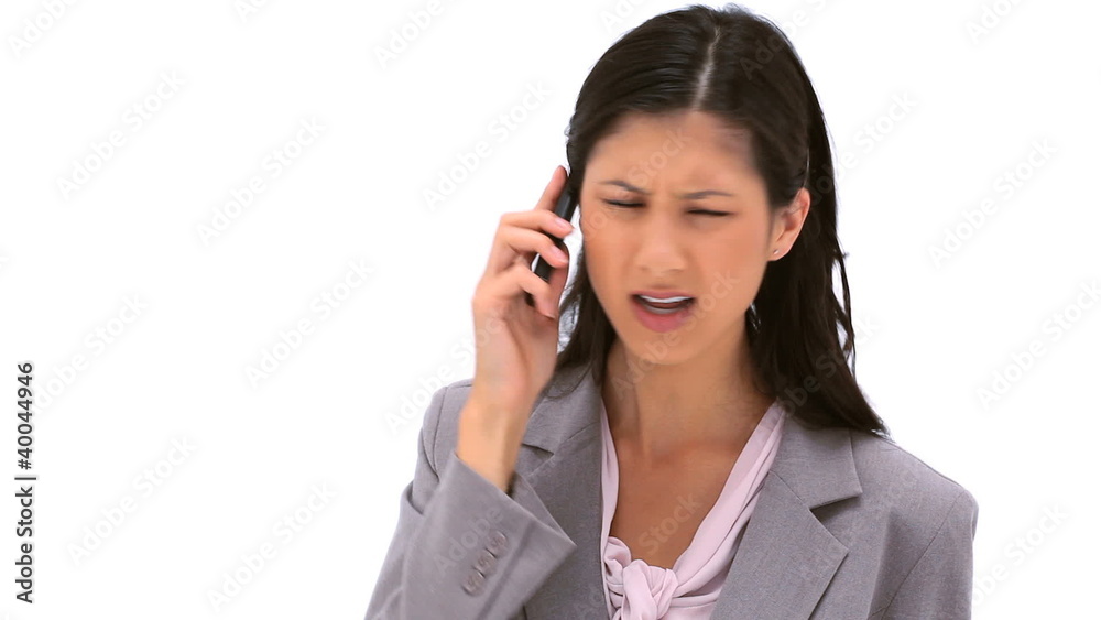 Serious brunette woman talking on her cellphone Serious brunette woman talking on her cellphone