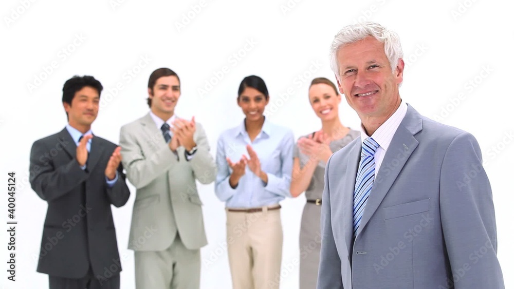 Boss being congratulated by co-workers Boss being congratulated by co-workers