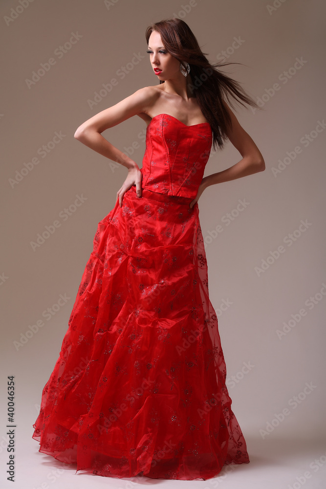 Young fashion model in red dress