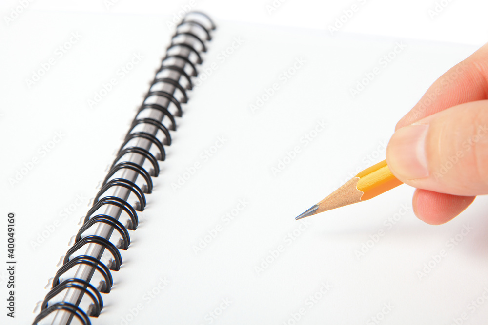Hand hold a pencil writing on notebook Hand hold a pencil writing on notebook