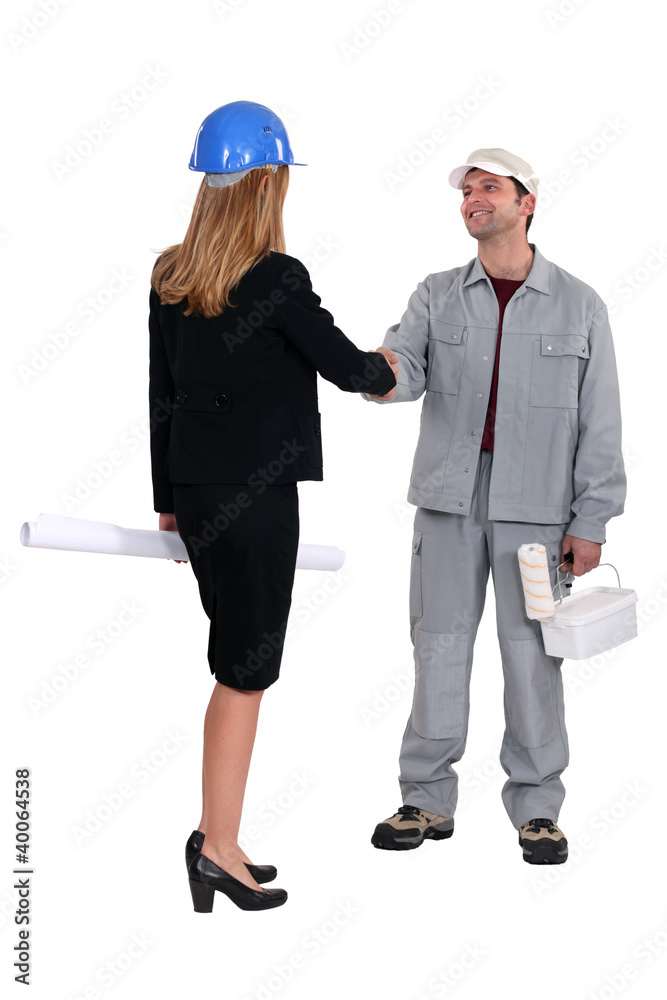 businesswoman and craftsman shaking hands businesswoman and craftsman shaking hands