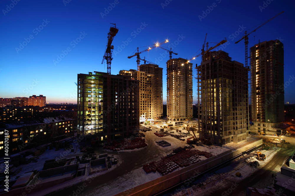 Seven high buildings under construction with cranes