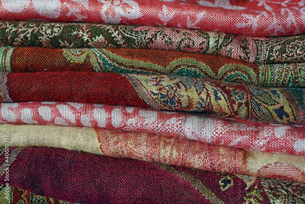 Pile Of Folded Colour Fabrics And Shawls Pile Of Folded Colour Fabrics And Shawls