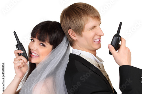 Dissatisfied young groom and bride speak on radio isolated