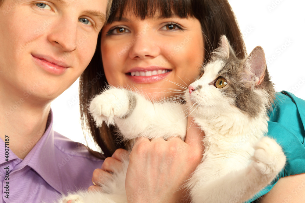 Smiling young husband and wife hold cat isolated Smiling young husband and wife hold cat isolated