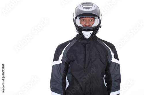 Motorcyclist wearing black jacket and helmet