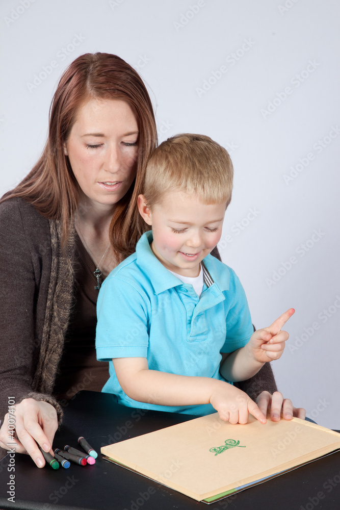 Mother and her happy blond son drawing together Mother and her happy blond son drawing together