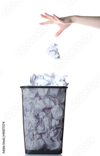 hand going garbage in metal trash bin from paper isolated