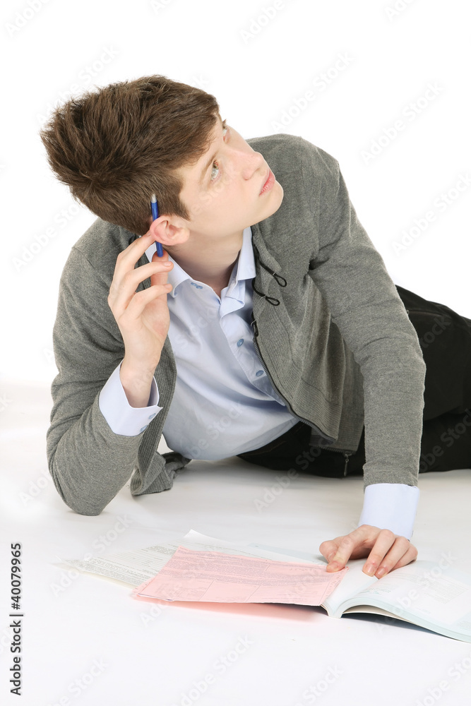 A young handsome college guy lying on the floor A young handsome college guy lying on the floor