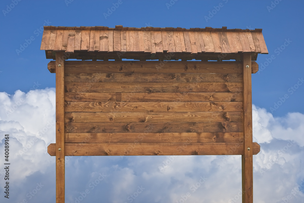 Fototapeta premium Wooden sign on a blue sky