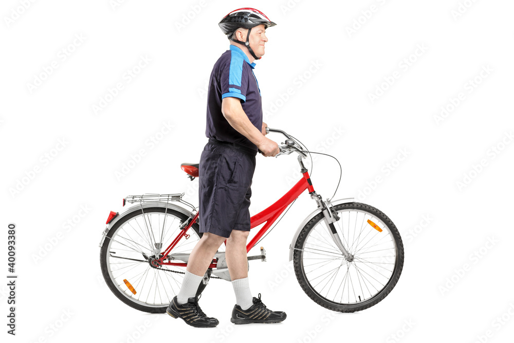 Obraz premium Full length portrait of a senior bicyclist pushing a bicycle