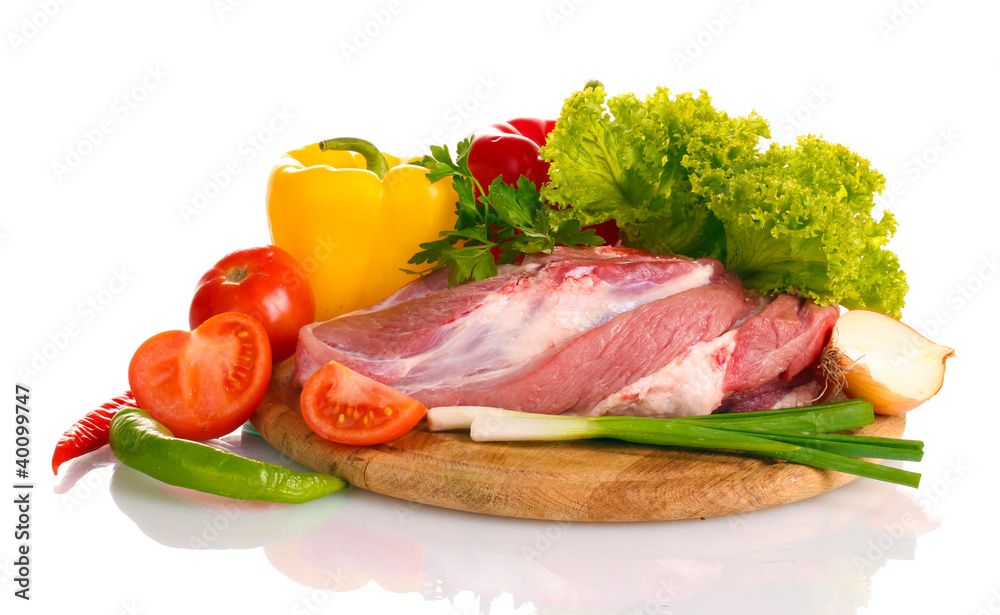 Raw meat and vegetables on a wooden board isolated on whitе Raw meat and vegetables on a wooden board isolated on whitе