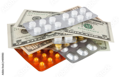 Pills and dollars isolated on white