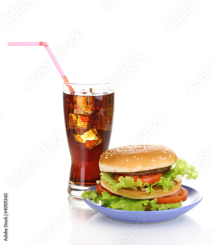 Big and tasty hamburger on plate with cola isolated on white