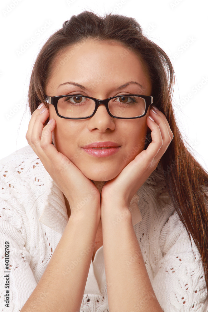 A young woman wearing glasses, her chin resting on her hands A young woman wearing glasses, her chin resting on her hands