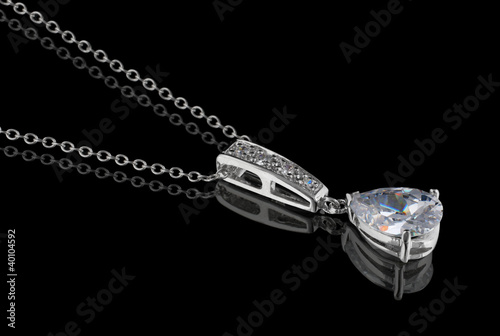 Diamond pendant with chain isolated on black