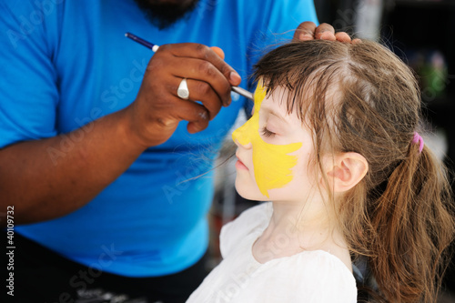 Cute little girl has her face painted