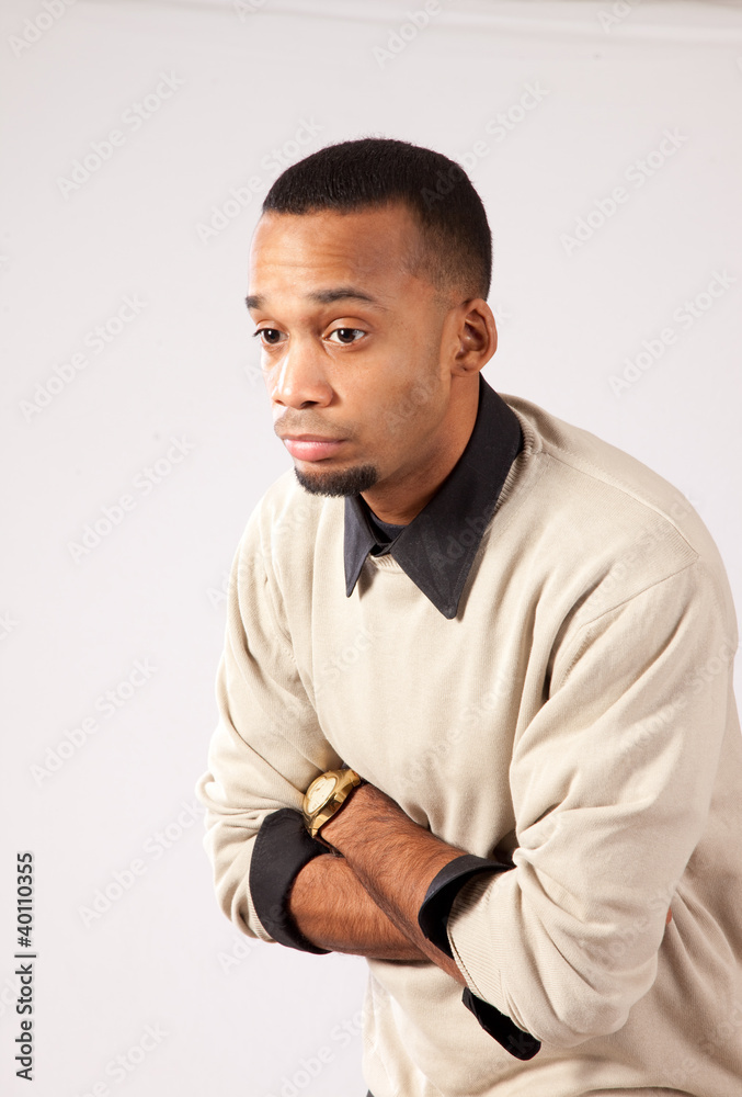 Handsome black man standing with arms crossed, thinking Handsome black man standing with arms crossed, thinking