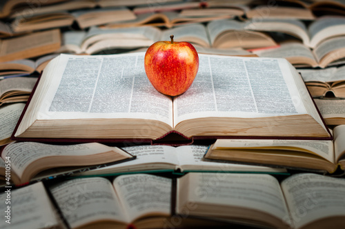 Red apple on big book photo