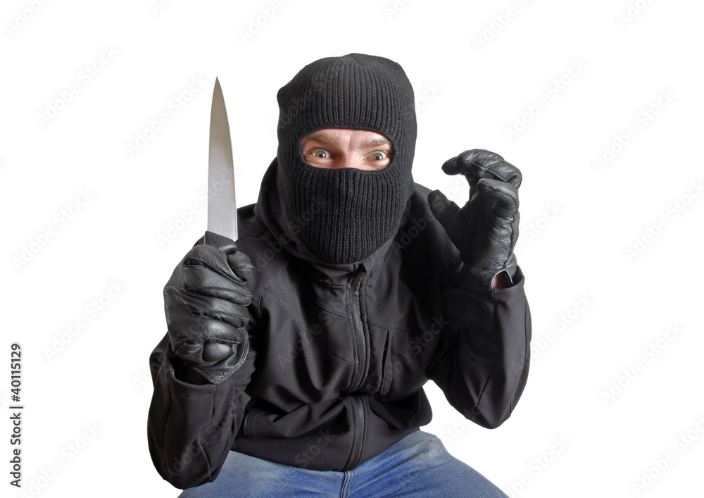 Masked criminal holding a knife, isolated on white Masked criminal holding a knife, isolated on white