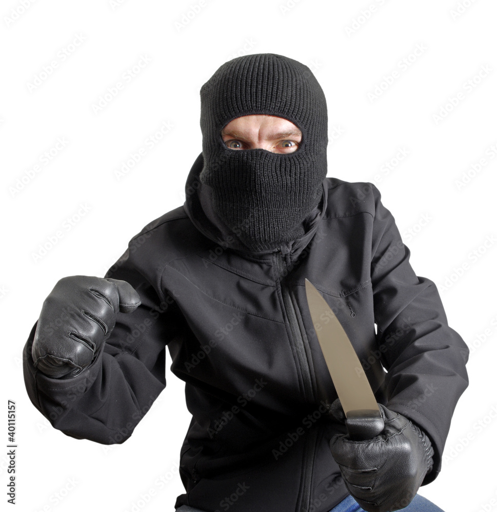 Masked criminal holding a knife, isolated on white Masked criminal holding a knife, isolated on white