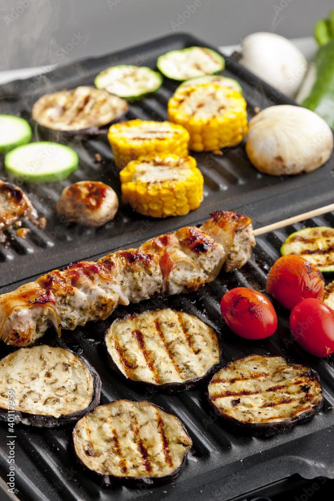 meat skewer and vegetables on electric grill meat skewer and vegetables on electric grill
