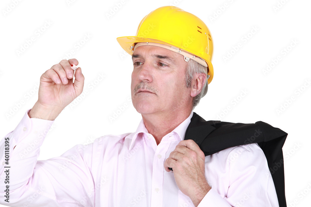 mature foreman with coat over shoulder examining pen mature foreman with coat over shoulder examining pen
