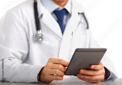 Handsome doctor using computer plane-table