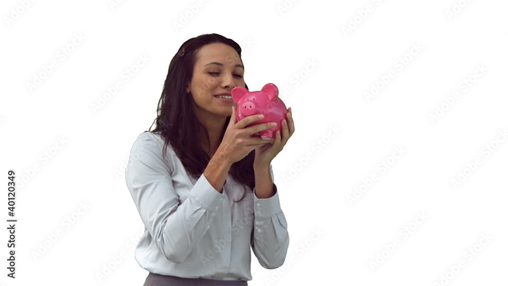 Brunette in slow motion kissing a piggy bank Brunette in slow motion kissing a piggy bank