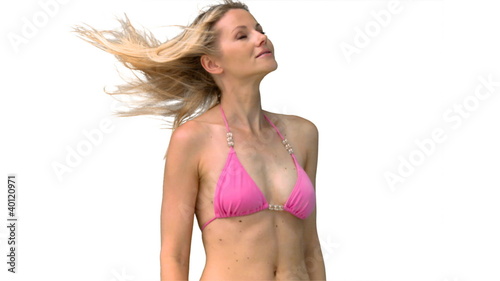 Woman in pink bikini turning head in slow motion