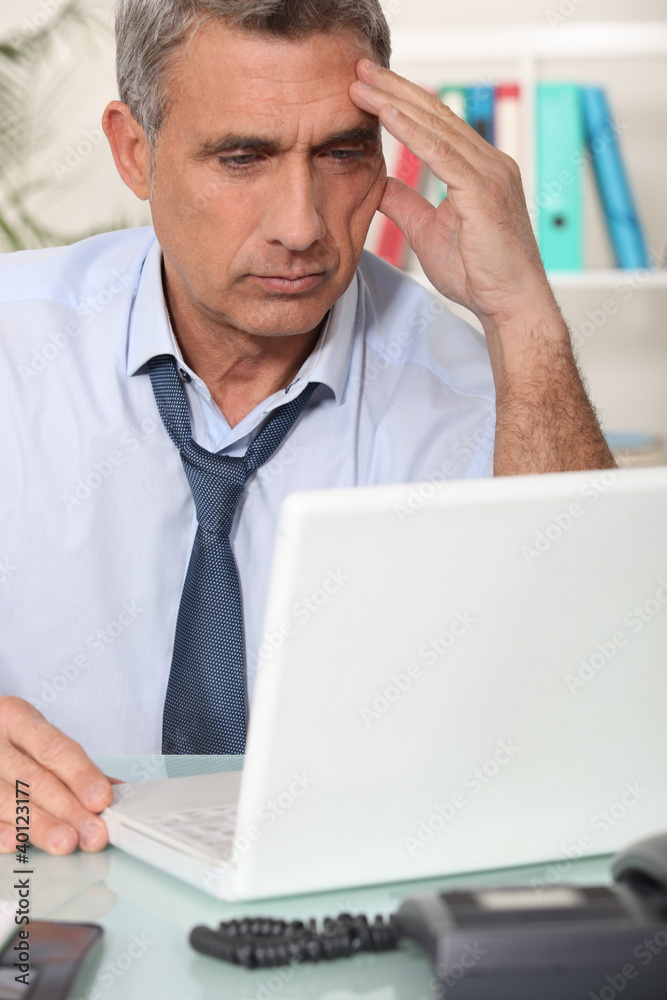 serious businessman working on his laptop serious businessman working on his laptop