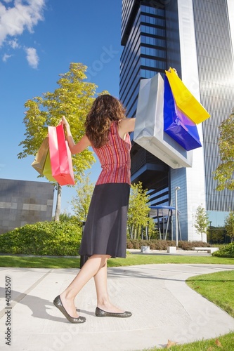 happy shopper woman down skyscrapers