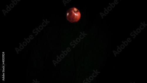 Red apple falling in super slow motion
