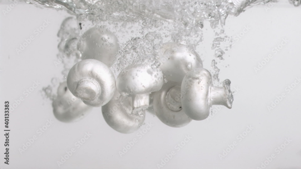 Mushrooms in super slow motion falling in the water Mushrooms in super slow motion falling in the water