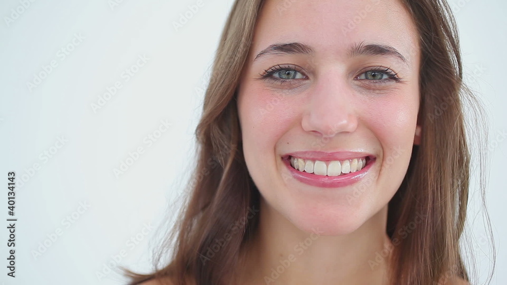 Smiling woman applying foundation on her face Smiling woman applying foundation on her face