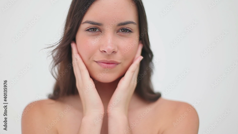 Peaceful woman massaging her cheeks Peaceful woman massaging her cheeks