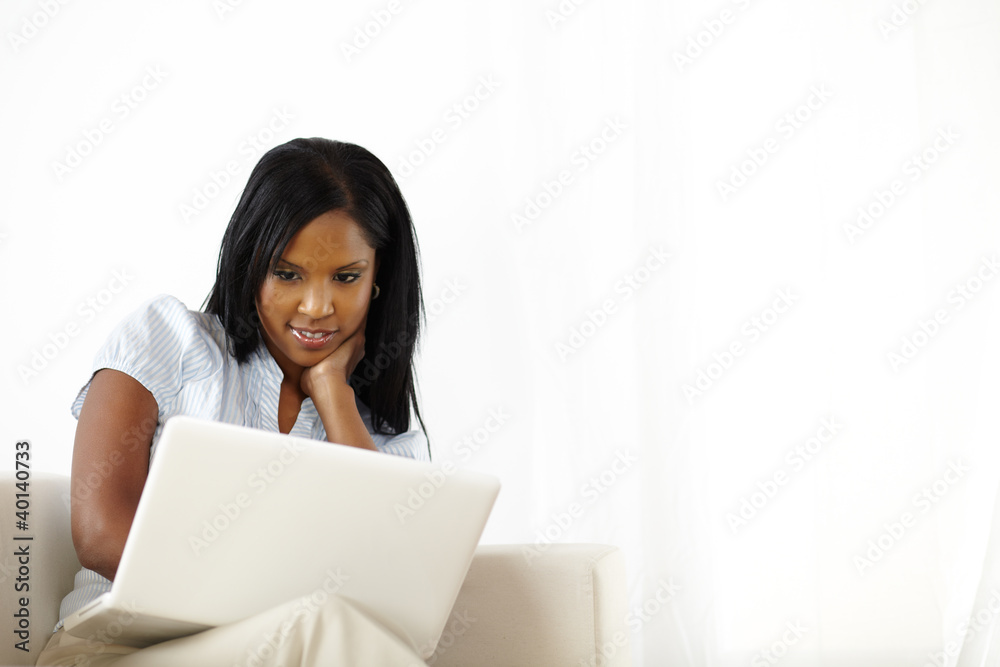 Calm young woman working on laptop at home Calm young woman working on laptop at home