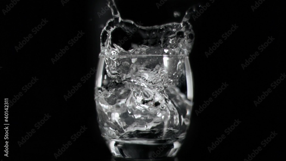 Ice cube falling in super slow motion in vodka Ice cube falling in super slow motion in vodka
